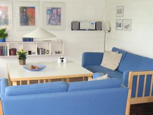 a living room with a blue couch and a table at 5 person holiday home in Aabenraa in Aabenraa