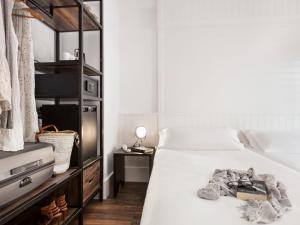a bedroom with a bed with a book on it at Delamar 4*Sup-Adults only (18+) in Lloret de Mar