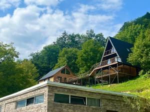 a house on top of a building on a hill at Glola LakeFront in Glola