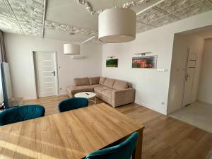 a living room with a table and a couch at Apartament Nidzicki in Nidzica
