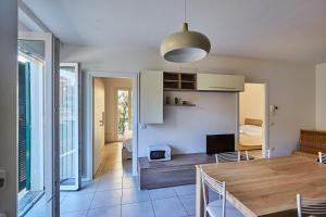a kitchen and dining room with a table and chairs at Affitti Brevi Liguria - Casamare in Varazze +12 photos