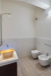 a white bathroom with a sink and a toilet at Affitti Brevi Liguria - Casamare in Varazze
