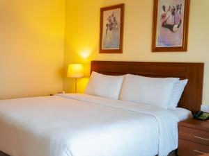 Ένα ή περισσότερα κρεβάτια σε δωμάτιο στο Abuja Continental Hotel