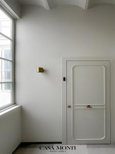 a white room with a white door and a window at CASA MONTI Sherry Suites in Jerez de la Frontera +4 photos