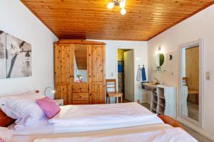 a bedroom with a bed and a wooden ceiling at Haus Am Bühl in Schönau im Schwarzwald
