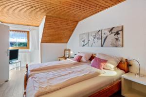 a bedroom with a bed with a wooden ceiling at Haus Am Bühl in Schönau im Schwarzwald