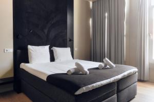 Llit o llits en una habitació de AmsterHome Hotel