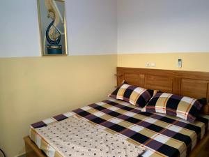 a bed with two pillows in a bedroom at Big apartment Yaoundé 2 rooms in Yaoundé