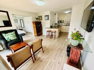 a living room with a couch and a table at D'urban Ridge Self catering Apartment in Cape Town