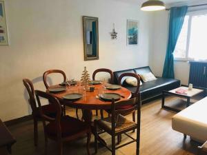a living room with a table and a couch at Maison familiale au cœur des Pyrénées ! in Argelès-Gazost +18 photos