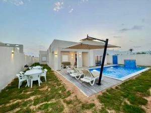 a villa with a swimming pool and a house at Villa Yara in Djerba