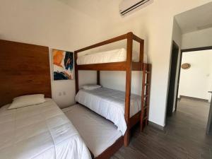 a bedroom with two bunk beds in a room at La Mar Monterrico in Monterrico +15 photos