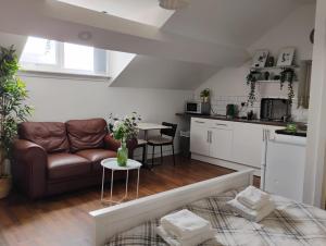 a living room with a couch and a table at CityNights Studios with Free Parking in Liverpool