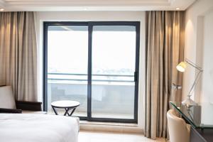 Ένα ή περισσότερα κρεβάτια σε δωμάτιο στο Abuja Continental Hotel