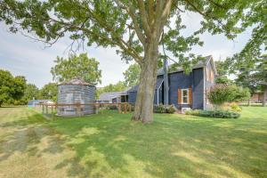 an exterior view of a house with a tree at City Girl Farmhouse in Hudsonville with Hot Tub in Hudsonville