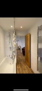 a bathroom with a bath tub and a shower at Seashells in Padstow