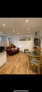 a living room with a glass table and a couch at Seashells in Padstow