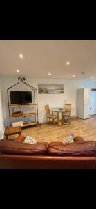 a living room with a bed and a table at Seashells in Padstow +15 photos