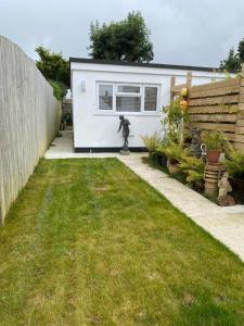 a backyard with a small white shed at Seashells in Padstow