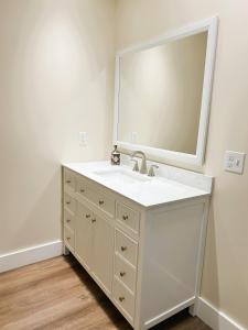 a bathroom with a white sink and a mirror at Hotel Pemaquid in Bristol +61 photos