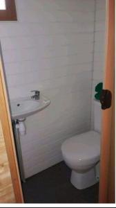 a bathroom with a toilet and a sink at La Petite Roulotte de la Bananeraie in Le Petit Brûlé