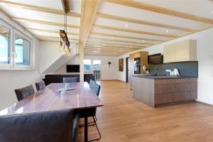a kitchen and dining room with a table and chairs at Kapellenhof Ferienwohnungen in Triberg