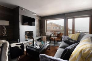 a living room with a couch and a fireplace at Pietra Serena in Verbier