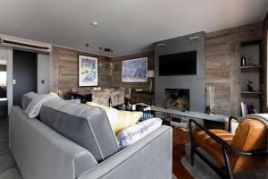 a living room with a couch and a tv at Pietra Serena in Verbier