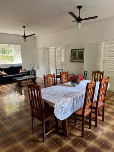 ein Esszimmer mit Tisch und Stühlen und einer Couch in der Unterkunft Suite em casa maravilhosa, melhor localização de Araruama in Araruama