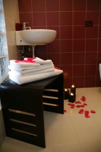 a bathroom with a sink and towels on a table at Venere B&B in Catania +37 photos