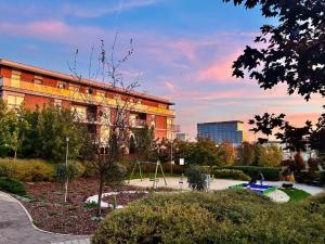 a building with a playground in front of a park at URBAN APARTMENTS PREMIUM Baildona No 11 FREE GARAGE, Self CHECK-IN in Katowice