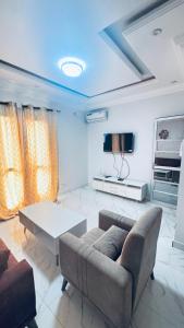 a living room with a couch and a table at SN Virage Almadie 2 in Dakar +22 photos