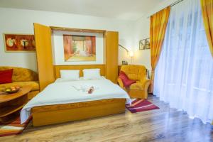 a bedroom with a bed and a couch at Vila Helena - Apartment Helena 2 in Ružomberok