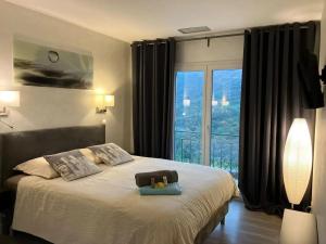 a bedroom with a bed with a large window at Maison conviviale à Fréjus avec piscine à débordement in Fréjus +31 photos