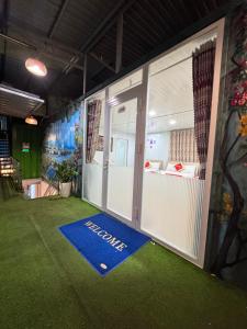 a clubhouse with a blue welcome mat on the floor at Phúc Đạt Container in Vung Tau