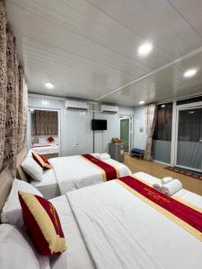 a large room with three beds in it at Phúc Đạt Container in Vung Tau