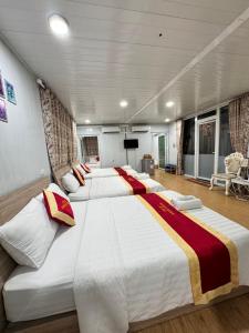 a group of four beds in a room at Phúc Đạt Container in Vung Tau