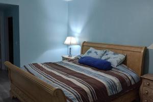 a bedroom with a bed with a blue wall at Luxurious, family-friendly 3BR condo on the water in Lantana +15 photos