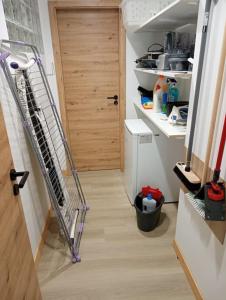 a hallway with a staircase leading to a kitchen with a door at L'elydiane in Hundling +10 photos