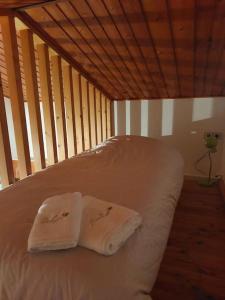 a bed with two towels on top of it at les collines de la Drôme in Saint-Martin-dʼAoût