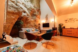 a living room with a large stone wall at Le Secret du Château in Beyren-lès-Sierck