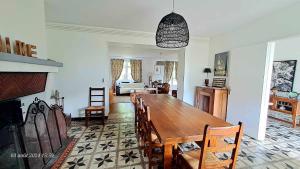 a dining room with a wooden table and chairs at Domaine de Cachaou Logis du Pujeau sauna & spa piscine chauffée in Salles