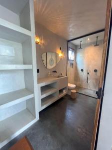 a bathroom with a shower and a sink and a toilet at 4 Coqueiros GURIU in Guriú