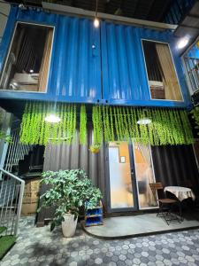 a blue house with a blue and green curtain at Phúc Đạt Container in Vung Tau
