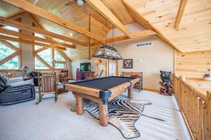 a game room with a pool table in a cabin at Magnificent Mountain Lodge in McHenry