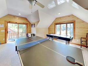 a kitchen with a ping pong table in a room at Magnificent Mountain Lodge in McHenry +80 photos