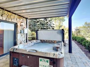 a jacuzzi tub sitting under a building at Magnificent Mountain Lodge in McHenry