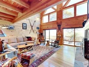 a living room with a couch and a table at Magnificent Mountain Lodge in McHenry