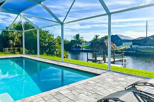 a swimming pool with a view of the water at Bliss Bungalow in Cape Coral