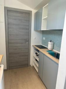 a kitchen with a gray door in a room at Fragrances of Istria - La Lavanda in Pula